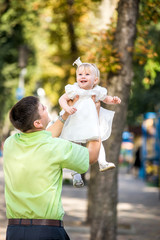 The man and his daughter in her arms.