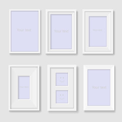 Set of white photo frames on the wall
