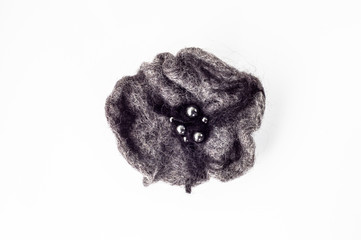 Felt brooch. Handmade stylish felt jewelry made with dark felt isolated on a white background.