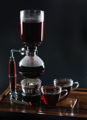 Puer tea in the siphon, shallow DOF, on black background