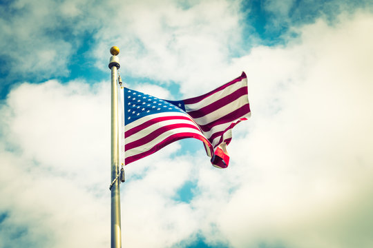 American flag on blue sky ( Filtered image processed vintage eff