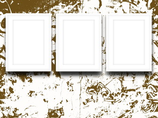 Close-up of three white picture frames on brown ink blotchy background