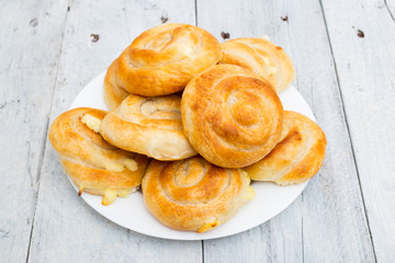 Homemade cheese bread rolls on a white wooden background