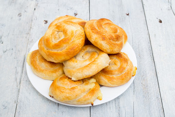 Homemade cheese bread rolls on a white wooden background