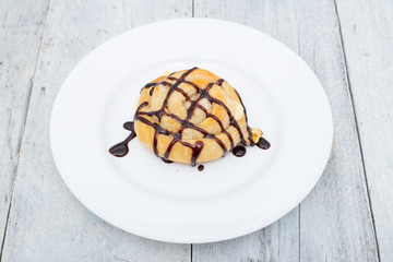 Homemade cheese bread rolls on a white wooden background