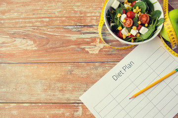 close up of diet plan and food on table