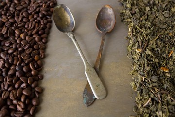 Beans of black coffee and  green tea leaves 
