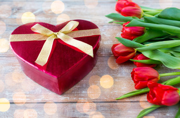 close up of red tulips and chocolate box