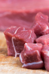 Beef steak cut into cubes. Red meat on the cutting board
