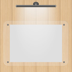 Empty frame on the wall with lighting on the wooden background