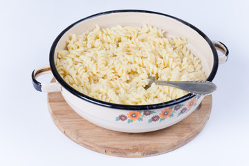 Boiled macaroni in the metal bowl