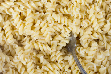 Boiled macaroni in the metal bowl