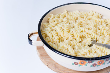 Boiled macaroni in the metal bowl