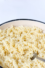 Boiled macaroni in the metal bowl