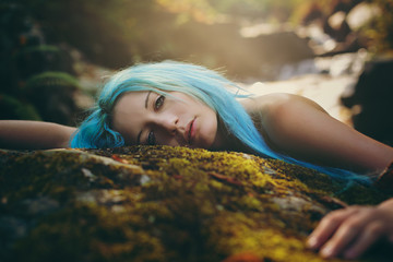 Beautiful dryad resting peacefully on a rock