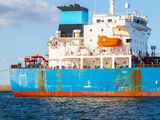 A lifeboat on the rear of a cargo ship.