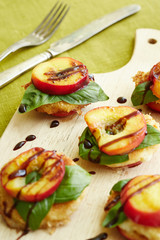 baked nectarine rounds decorated with basil and chocolate