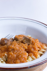 Served beef stew with macaroni in the metal plate