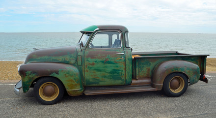  Classic pickup truck with some rust on Felixstowe seafront. - obrazy, fototapety, plakaty