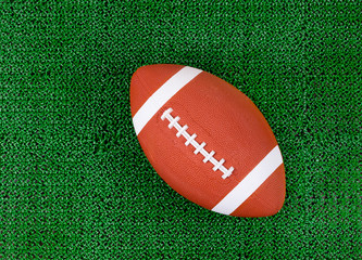 American football on artificial green grass turf field