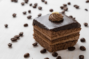chocolate cake and coffee beans on table