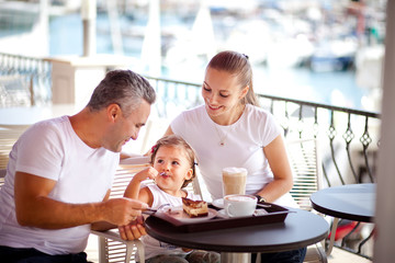Girl with parents at a cafe