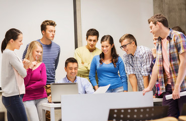 group of students and teacher with laptop