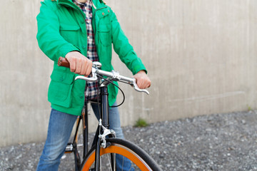close up of man with fixed gear bike on street