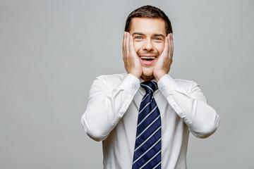 Handsome stylish businessman on grey background
