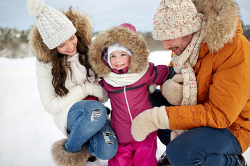 Obraz premium happy family with child in winter clothes outdoors