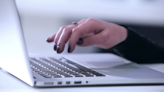 Female hands wrighting on laptop
