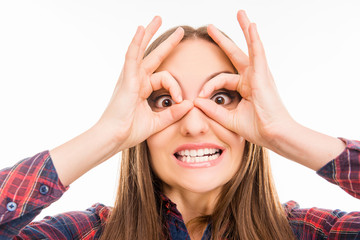 comic crazy girl holding fingers near eyes like glasses and grim