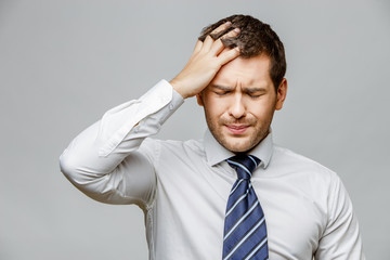 Handsome stylish businessman on grey background