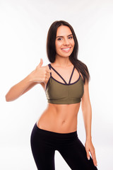 Fototapeta na wymiar Attractive fitness woman showing trained body and gesturing 