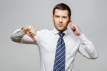 Handsome stylish businessman on grey background