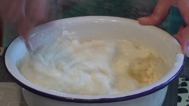 The woman knead the dough for a pie