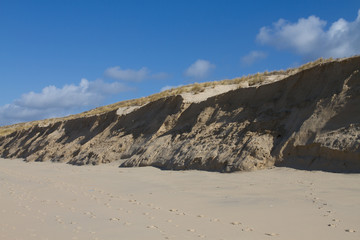 Fototapeta na wymiar Sand Dunes on Windy Day with blue sky