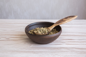 green coffee on a wooden background