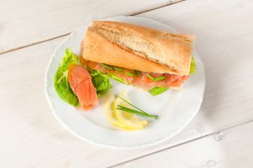 salmon baguette with lemon, tomato and chives