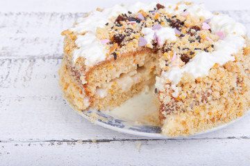 Biscuit cake with crumbs, whipped cream
