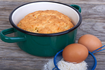Biscuit, cake in shape for baking, saucepan
