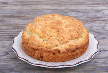 Biscuit, cake on plate on a wooden