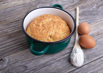 Biscuit, cake in shape for baking, saucepan