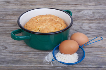 Biscuit, cake in shape for baking, saucepan
