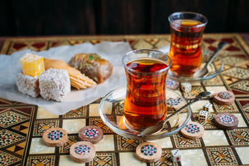 Turkish sweets and tea on the backgammon Board