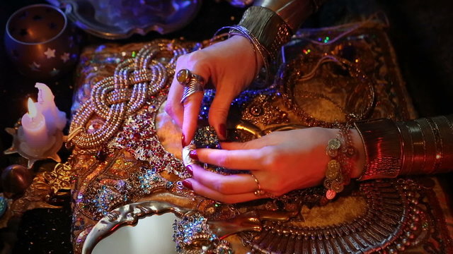 Golden  Oriental Jewelry and Accessories: Female Hands with beautiful National Indian Jewellery, Eastern Arabian Fairy Tale (Harem), Wedding Luxury Fashion and Beauty. Eastern Treasure by Candlelight.
