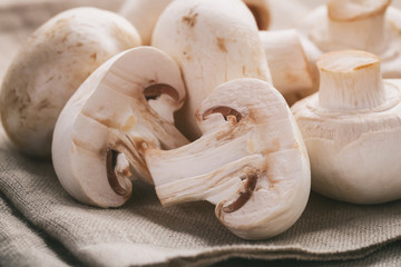 fresh white champignon on wood table, vintage toned