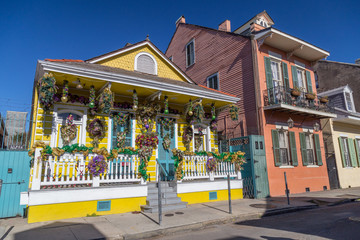 Old Colonial Houses on the Streets of French Quarter decorated for Mardi Gras in New Orleans, ...