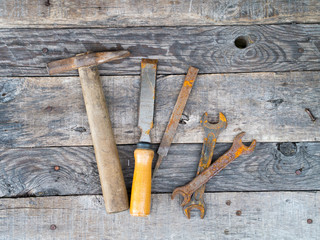 Old rusty vintage tools on weathered grey background