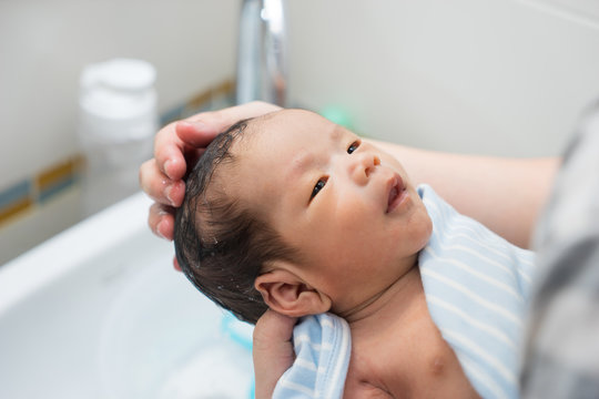 Asian Newborn Baby Having A Bath